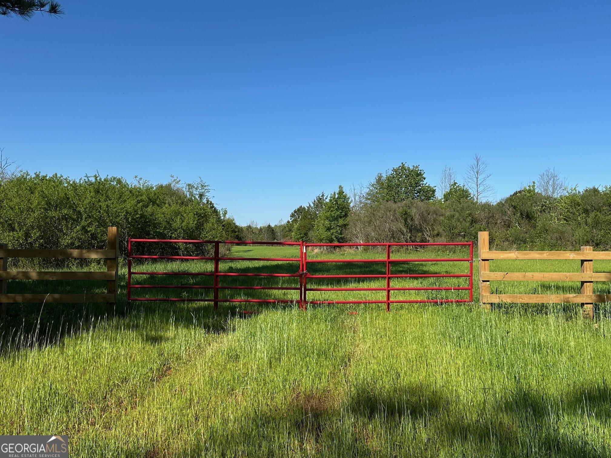 0 West Road Williamson, GA 30292 - Photo 6 of 13 a view of a lake with houses in the background