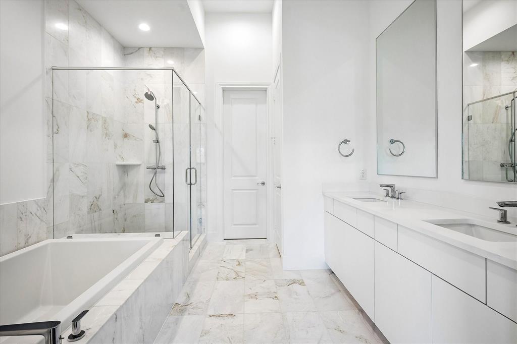 6019 Laurel Lane Addison, TX 75001 - Photo 6 of 21 Bathroom featuring a full-length tub, glass-enclosed shower, dual vanity with undermount sinks, and tiled flooring