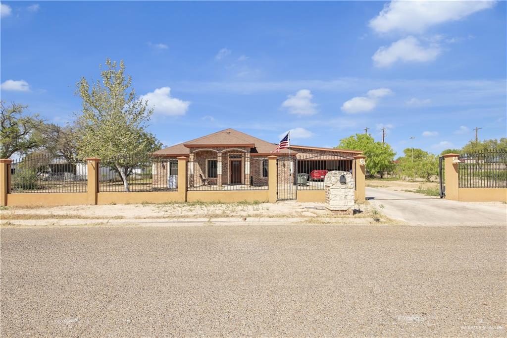 814 West 2nd Street Mission, TX 78572 - Photo 1 of 25 a front view of a house with a garden and pathway