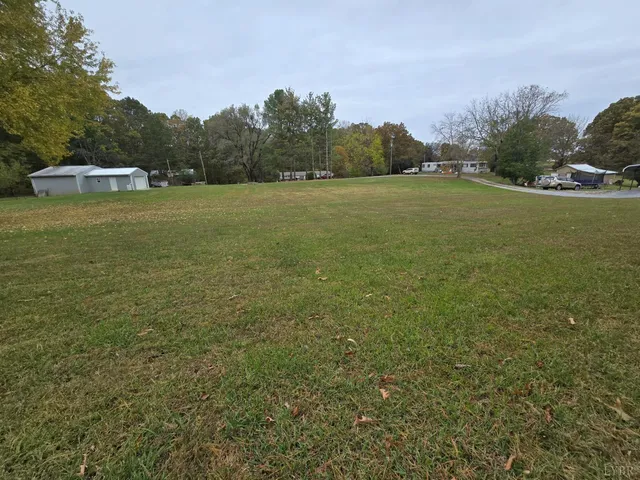 a view of a field with trees in the background