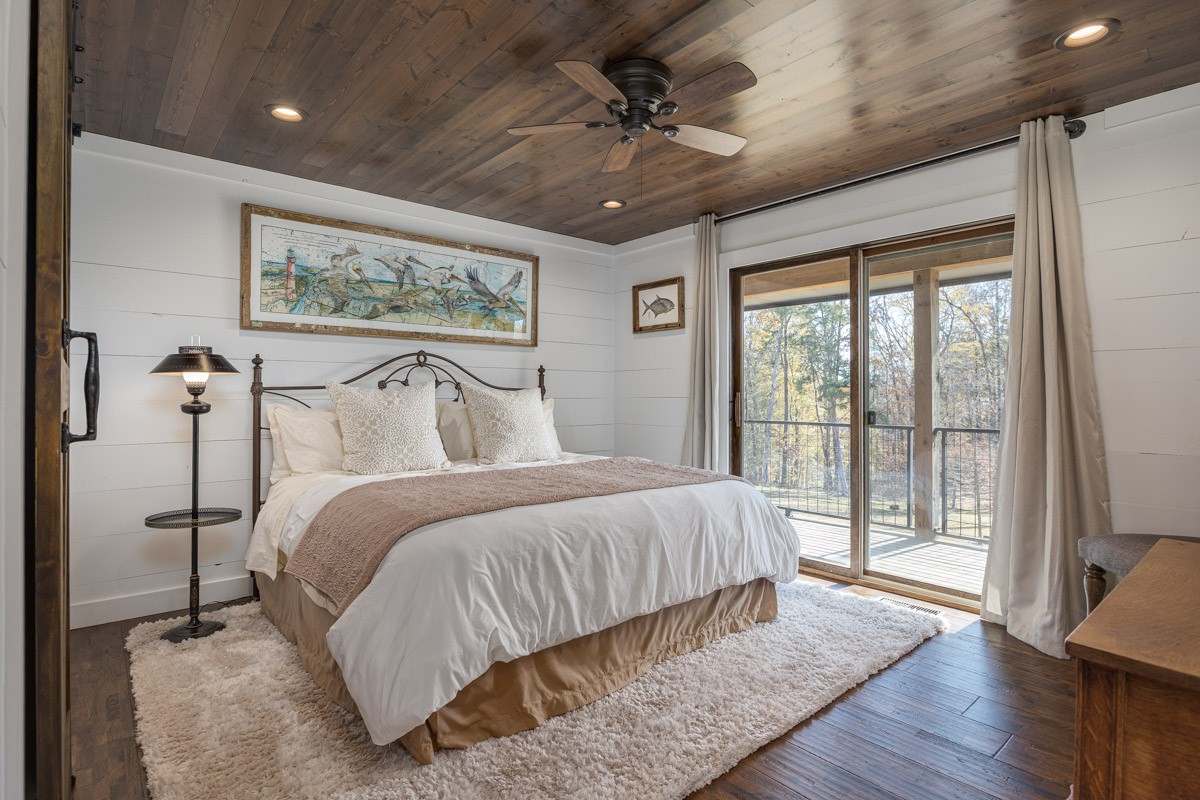 2900 Tanyard Hill Road Lynchburg, TN 37352 - Photo 16 of 83 a bedroom with a large bed and a large window