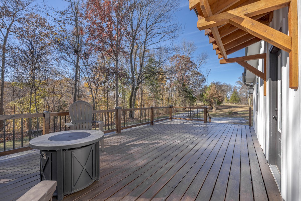 2900 Tanyard Hill Road Lynchburg, TN 37352 - Photo 57 of 83 a view of a patio with table and chairs and wooden floor