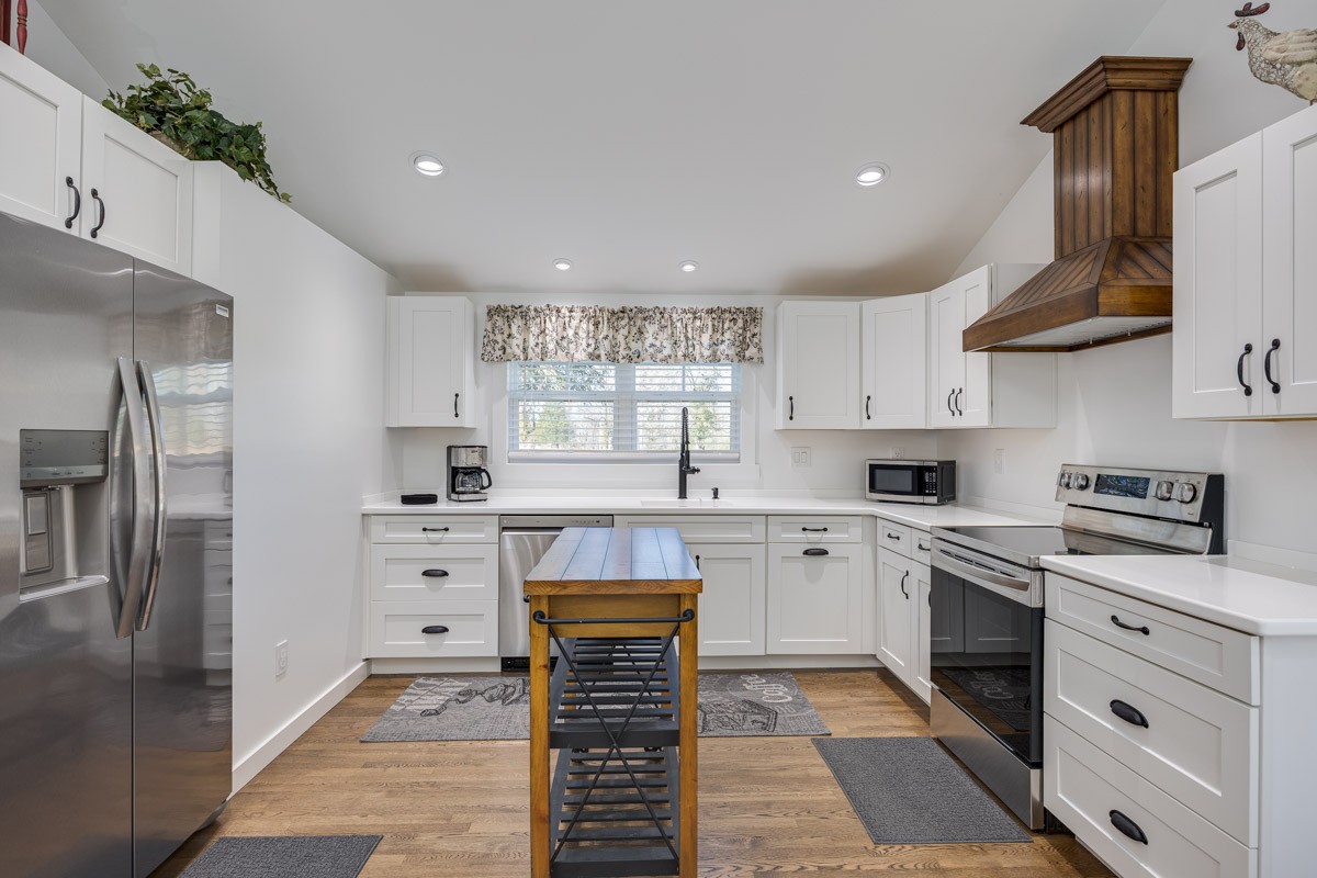 2900 Tanyard Hill Road Lynchburg, TN 37352 - Photo 73 of 83 a kitchen with white cabinets stainless steel appliances and a counter space