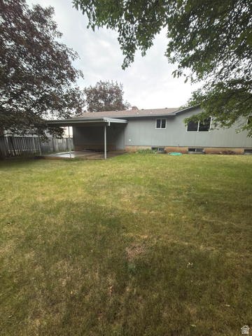 1164 East Mountain Road Logan, UT 84321 - Photo 41 of 45 Rear exterior with covered patio, expansive lawn, and mature perimeter trees