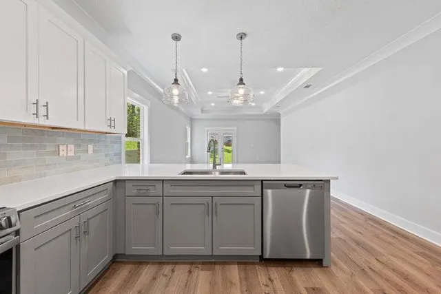 a kitchen with a sink window and cabinets