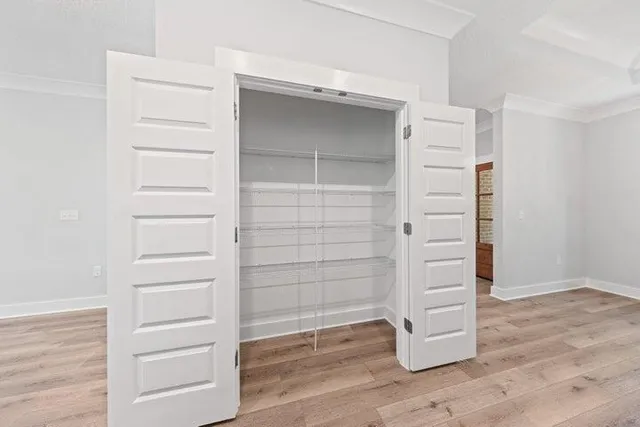 a view of walk in closet with empty racks