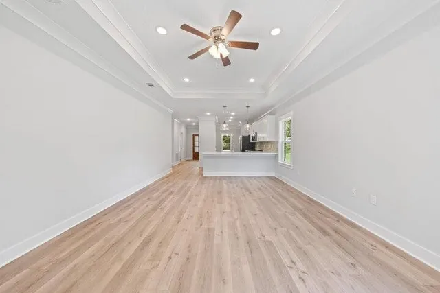 wooden floor in an empty room with a ceiling fan