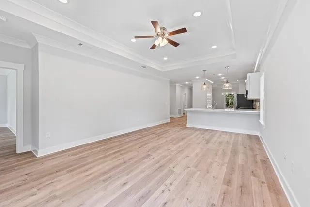 wooden floor in an empty room with a ceiling fan