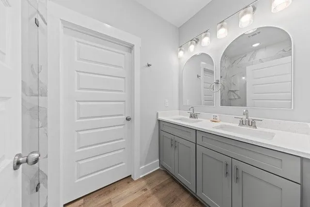 a bathroom with a double vanity sink and mirror