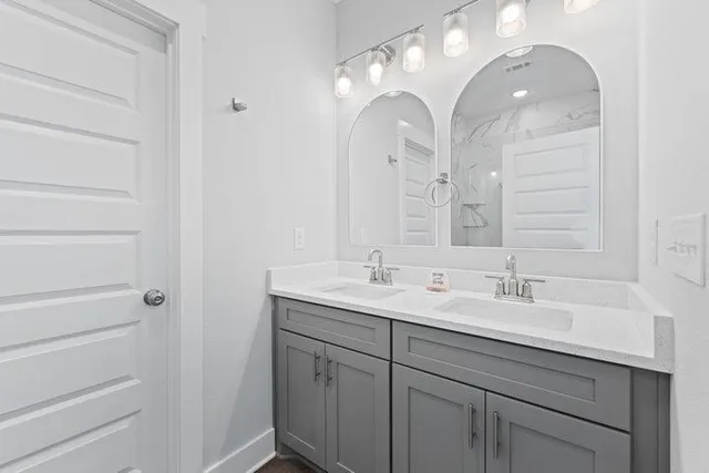 a bathroom with a double vanity sink and a mirror