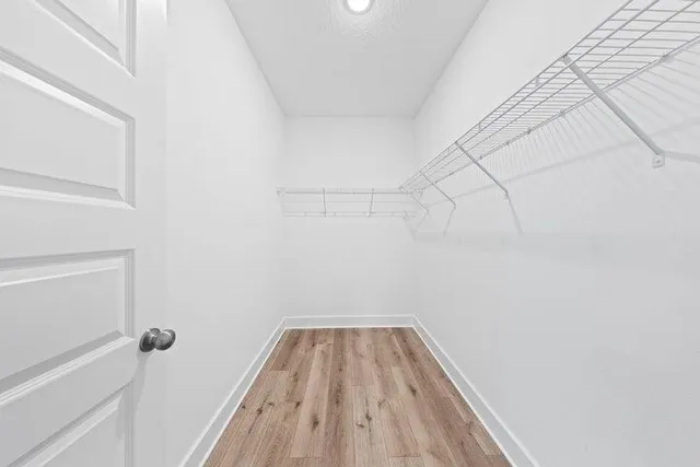 a view of a room with wooden floor