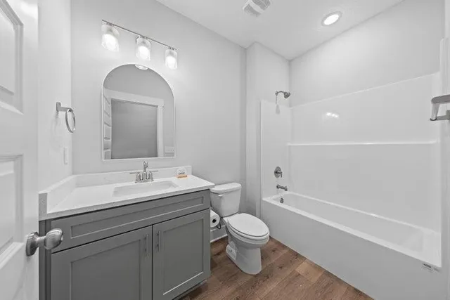 a bathroom with a toilet a sink and bathtub