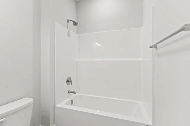 a bathroom with a bathtub and a toilet