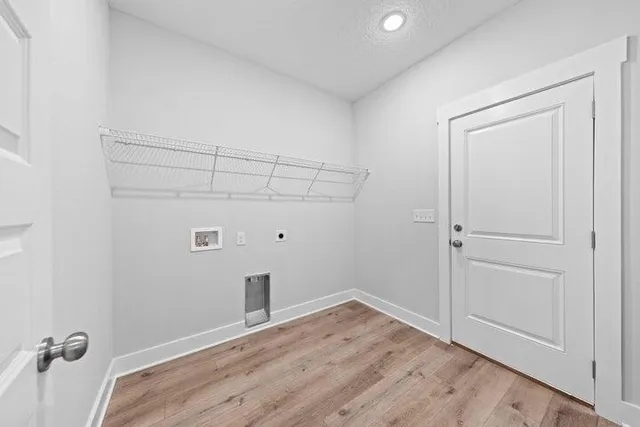 a view of a room with wooden floor