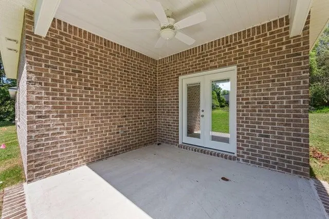 a view of a porch with a floor to ceiling window next to a yard