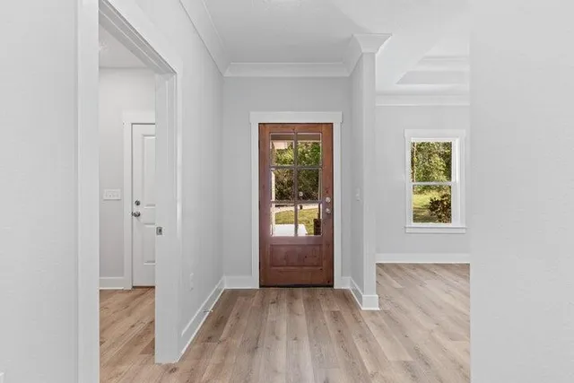 a view of an entryway with wooden floor