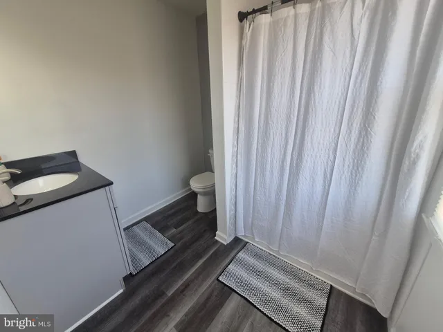 a bathroom with a toilet and a shower curtain
