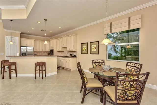 a view of a dining room with furniture and chandelier