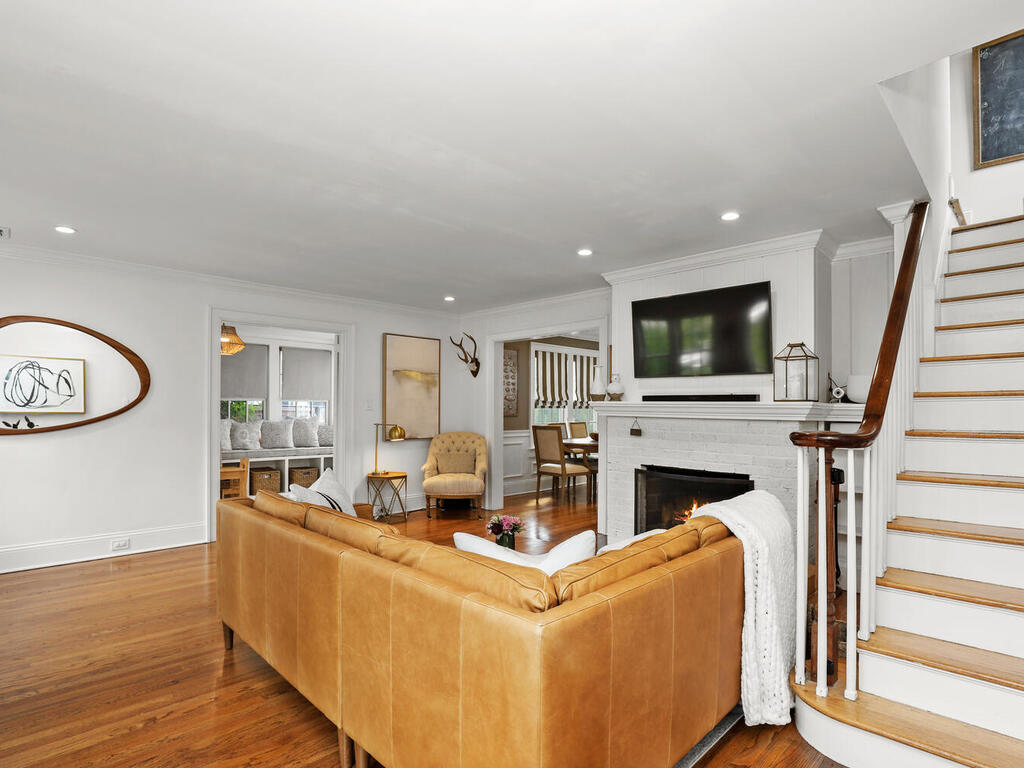 2636 Boston Post Road Darien, CT 06820 - Photo 3 of 28 a living room with furniture a fireplace and a flat screen tv