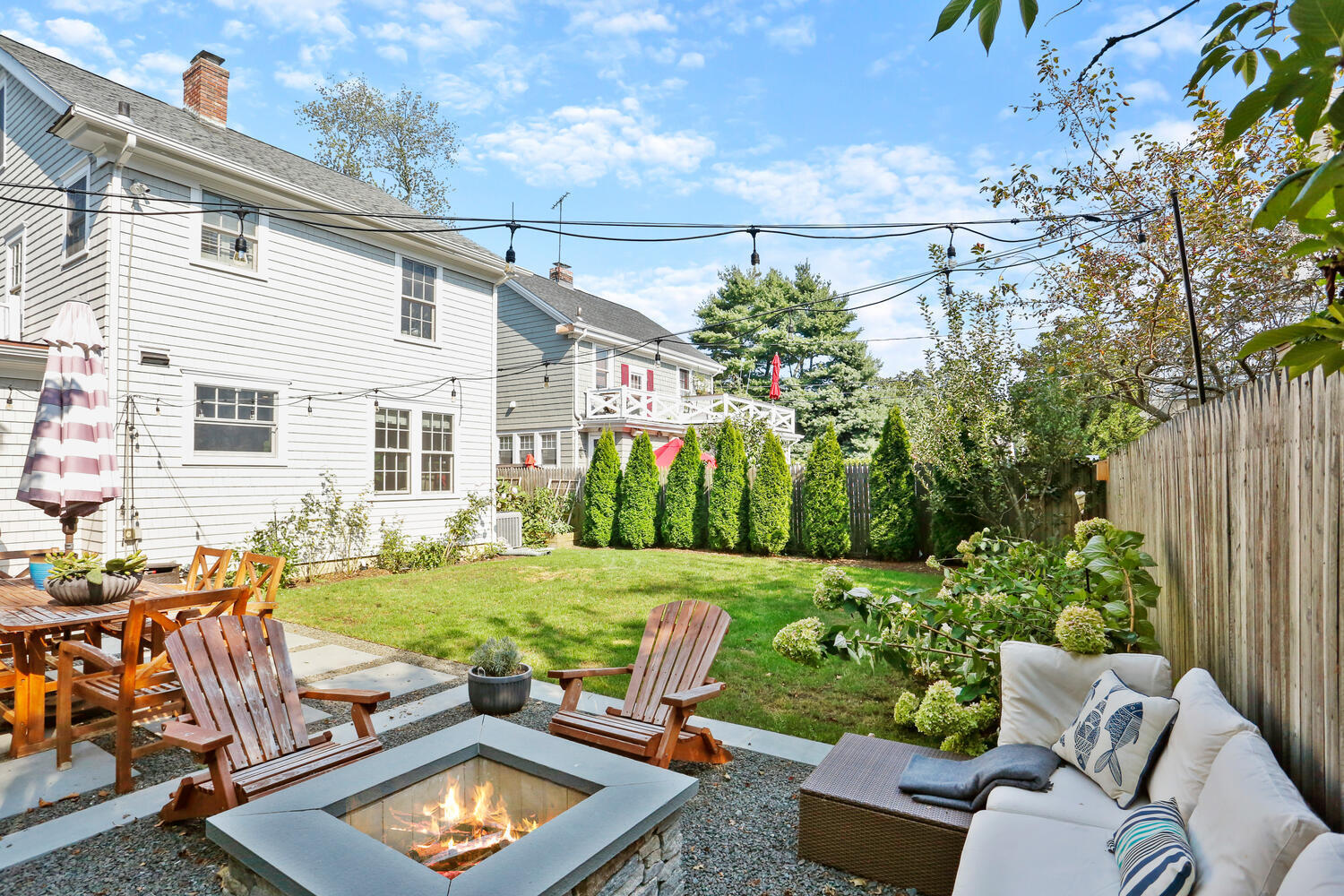 2636 Boston Post Road Darien, CT 06820 - Photo 21 of 28 a view of a backyard with couches plants and large trees