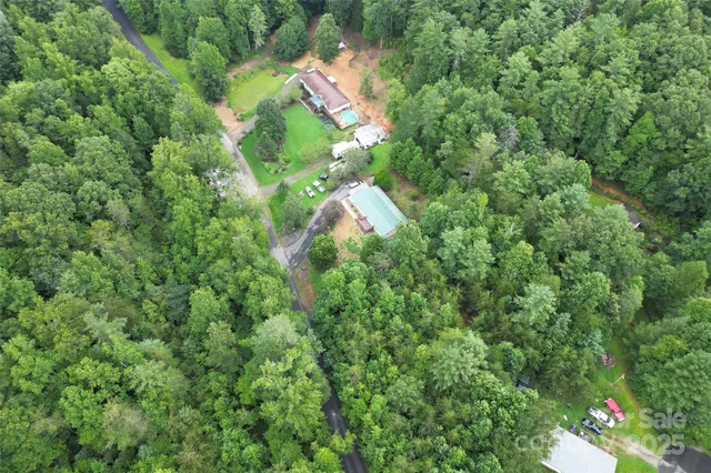 an aerial view of a house with a yard and trees