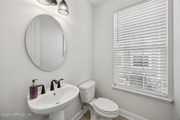 a front view of a house with a garden and garage