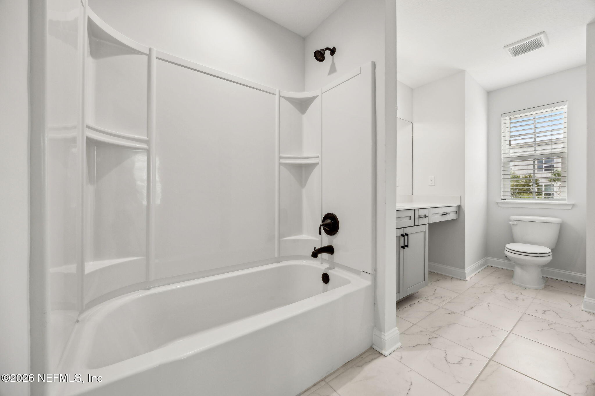 230 Wildlight Avenue Yulee, FL 32097 - Photo 27 of 73 a bathroom with a bathtub and a toilet