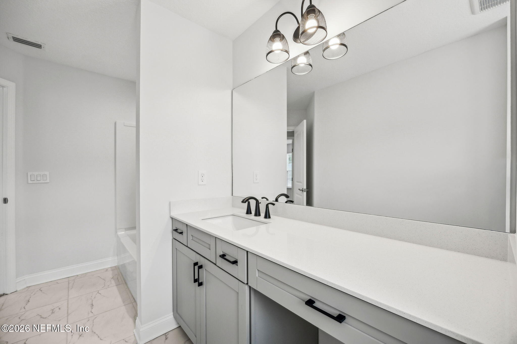 230 Wildlight Avenue Yulee, FL 32097 - Photo 28 of 73 a bathroom with a sink a vanity and a mirror