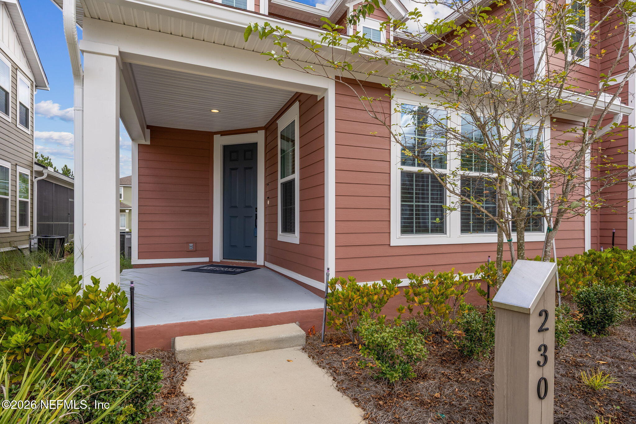 230 Wildlight Avenue Yulee, FL 32097 - Photo 4 of 73 a front view of a house with a garden
