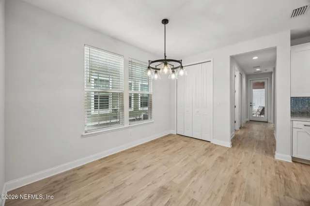 a bathroom with a toilet a sink a mirror and a window