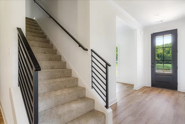 a view of entryway and hall with wooden floor