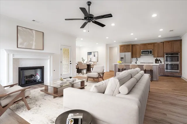 a living room with furniture kitchen view and a fireplace