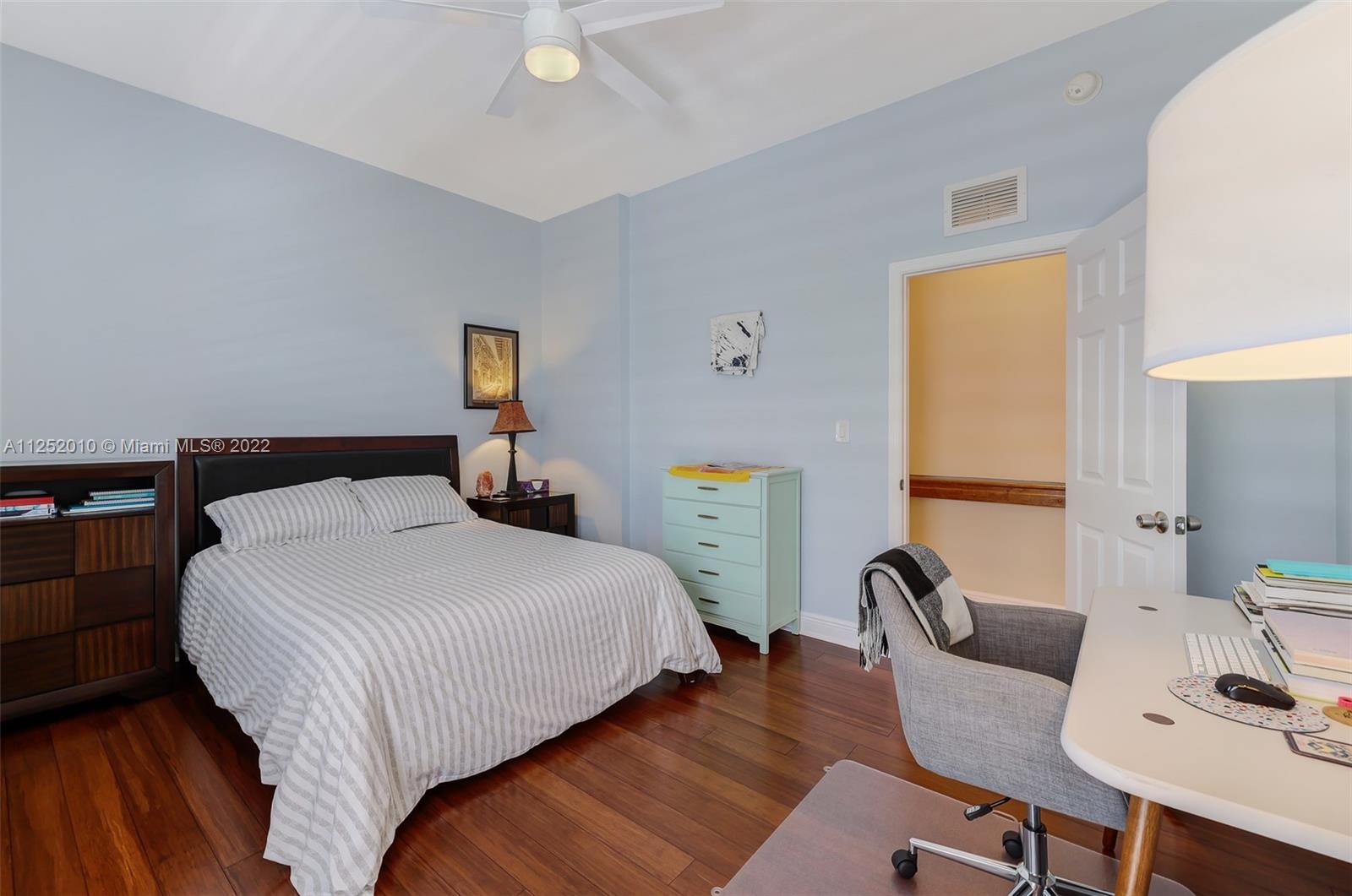 1037 Southwest 9th Court, Unit E1 Miami, FL 33130 - Photo 11 of 26 a bedroom with bed chair and wooden floor