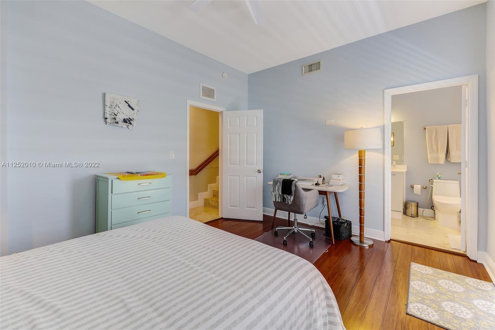 1037 Southwest 9th Court, Unit E1 Miami, FL 33130 - Photo 12 of 26 a bedroom with a bed and a table in it