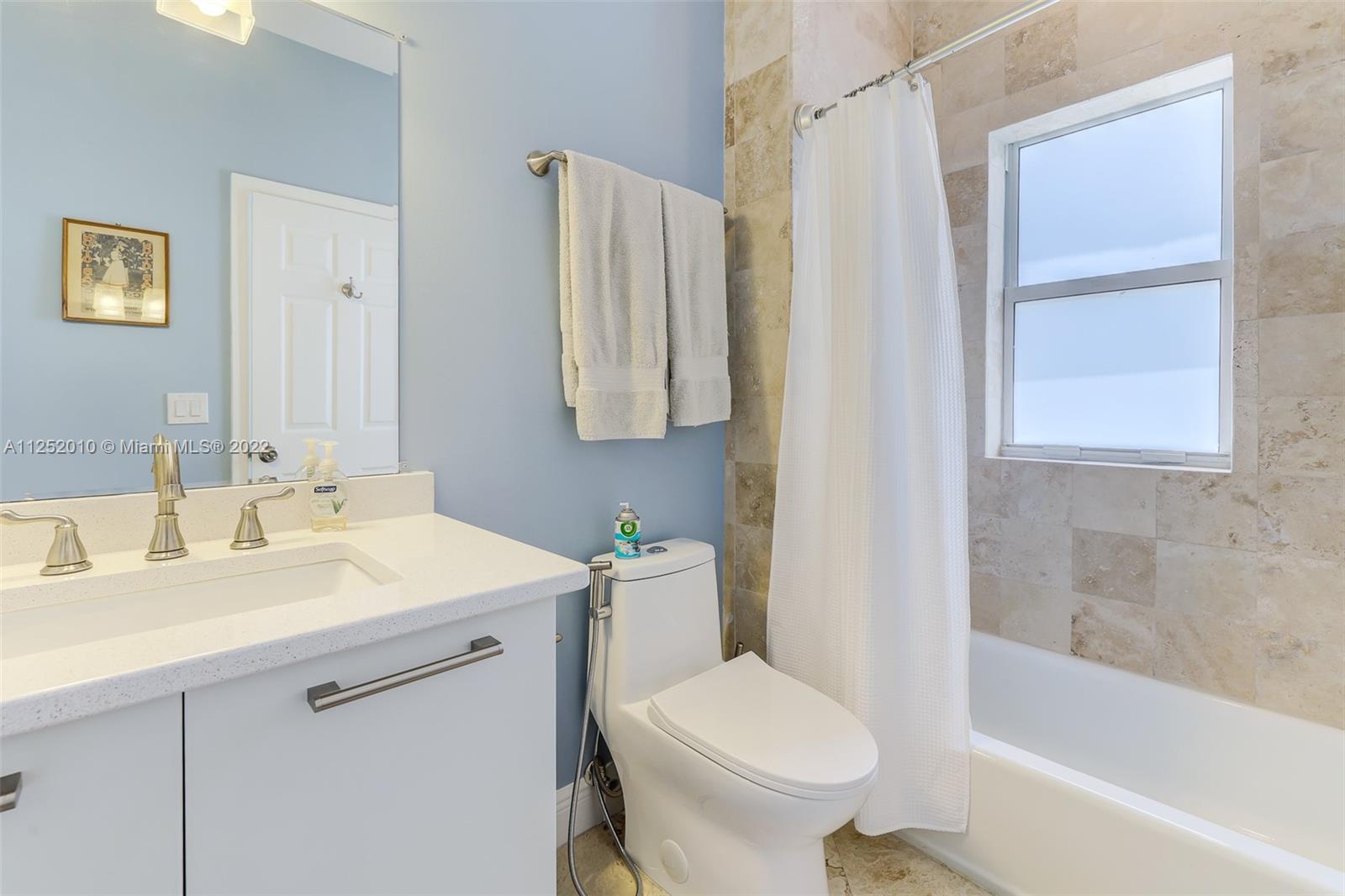1037 Southwest 9th Court, Unit E1 Miami, FL 33130 - Photo 13 of 26 a bathroom with a sink toilet and shower