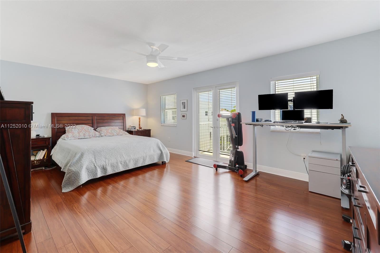 1037 Southwest 9th Court, Unit E1 Miami, FL 33130 - Photo 14 of 26 a bedroom with a bed and a flat screen tv