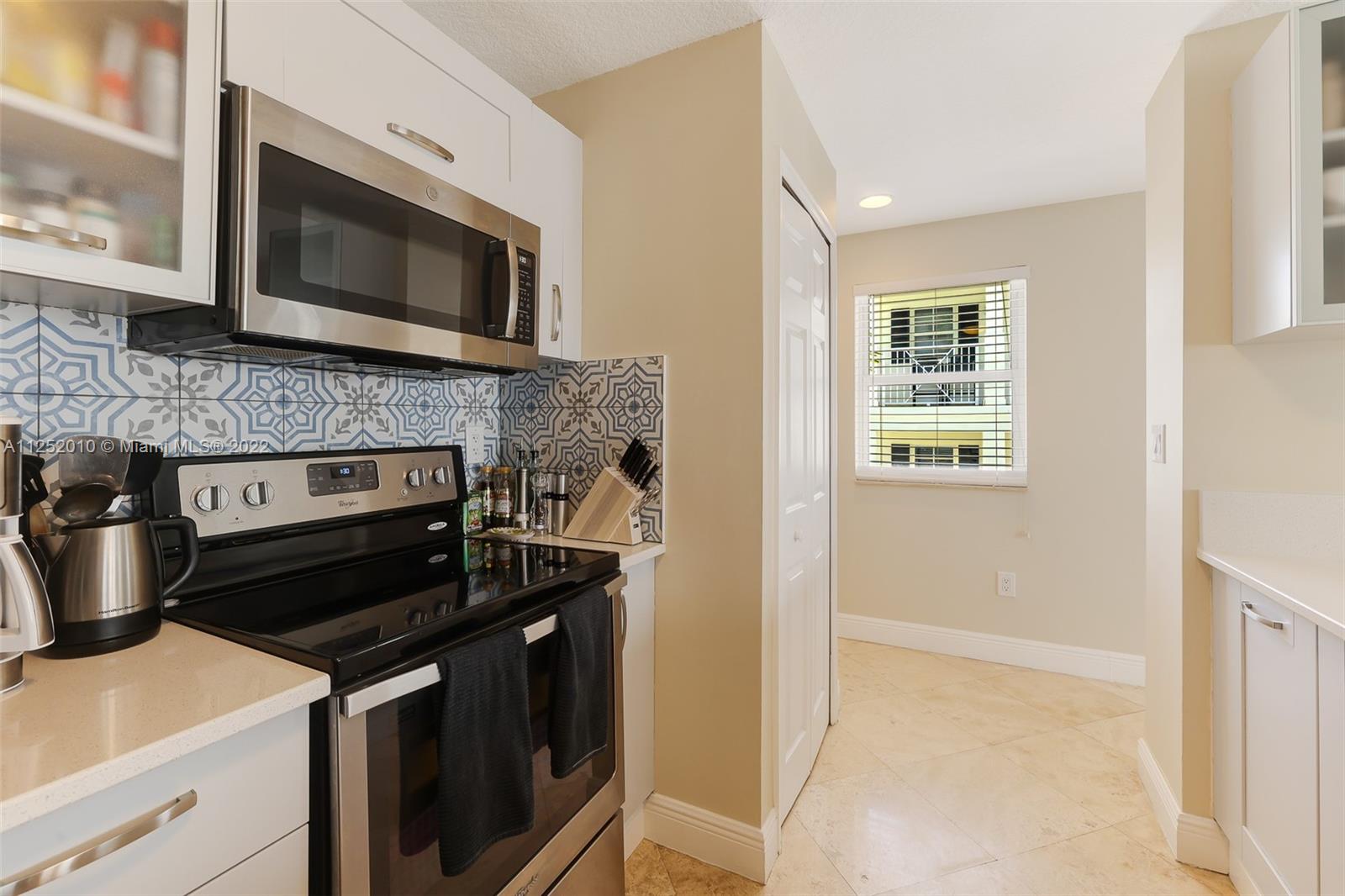 1037 Southwest 9th Court, Unit E1 Miami, FL 33130 - Photo 6 of 26 a kitchen with a stove and a microwave