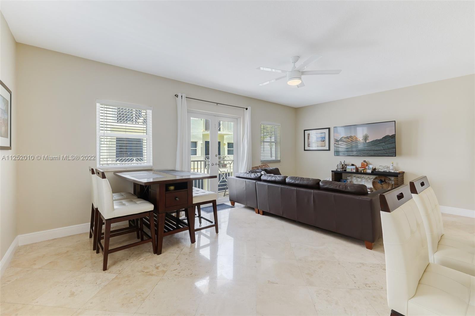 1037 Southwest 9th Court, Unit E1 Miami, FL 33130 - Photo 7 of 26 a living room with furniture a dining table and a window