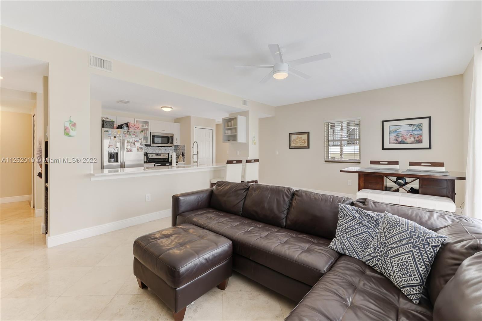 1037 Southwest 9th Court, Unit E1 Miami, FL 33130 - Photo 9 of 26 a living room with furniture and kitchen view