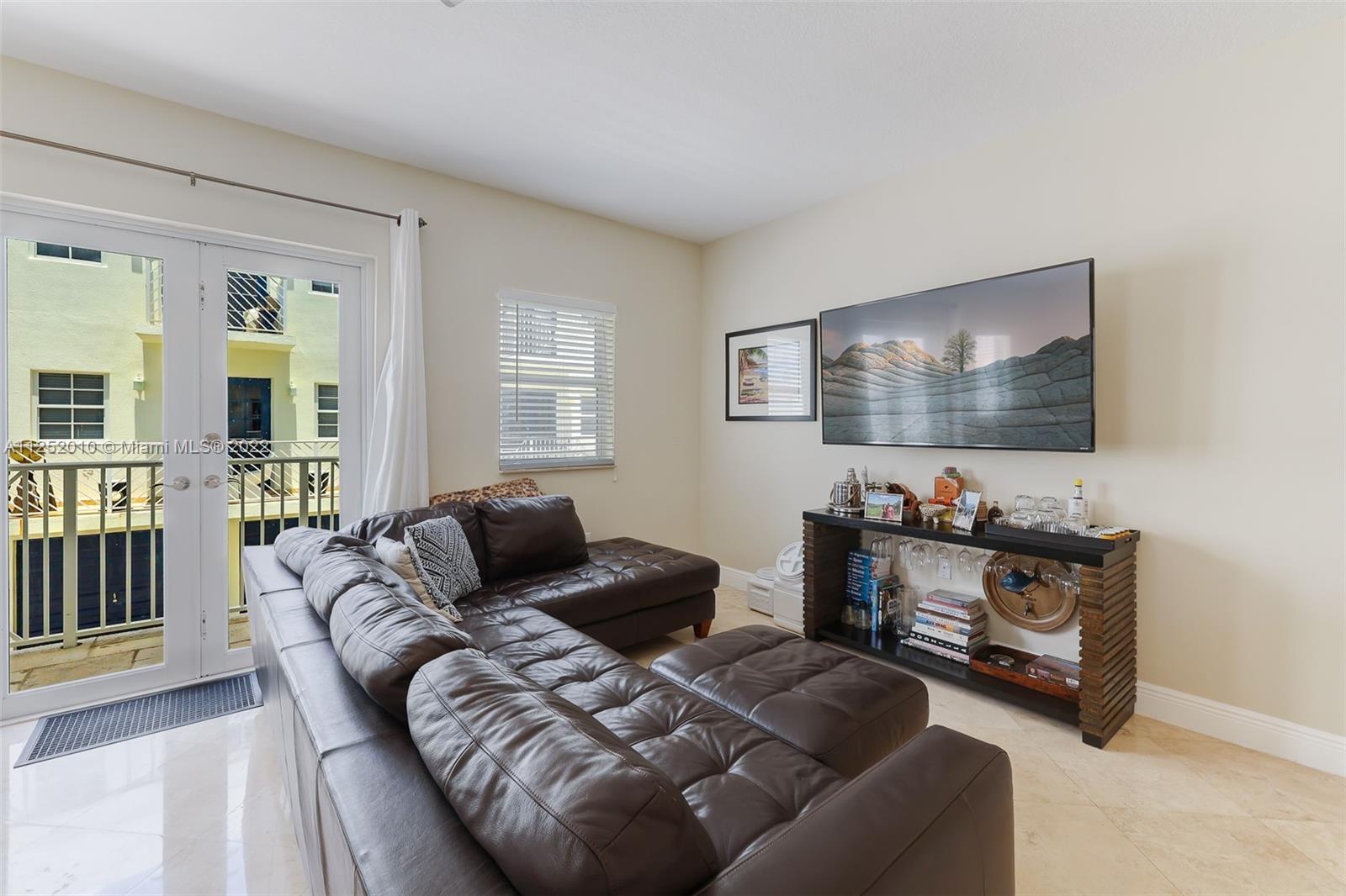 1037 Southwest 9th Court, Unit E1 Miami, FL 33130 - Photo 10 of 26 a living room with furniture and a flat screen tv