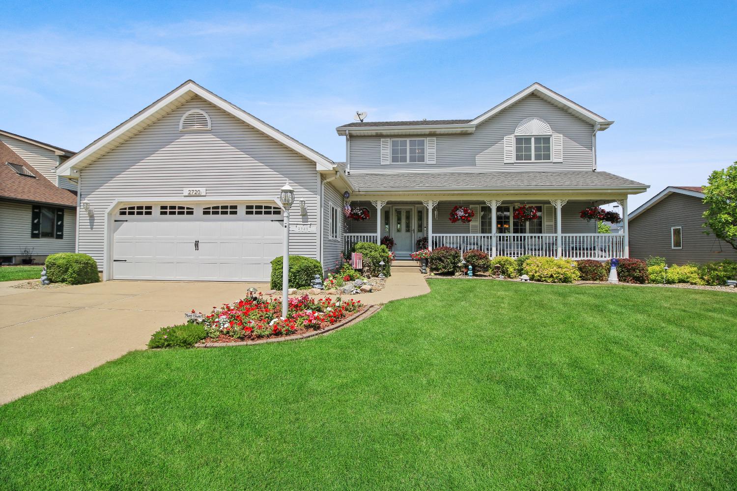 a view of a house with a big yard and potted plants