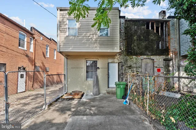 a view of a house with a door and wooden walls