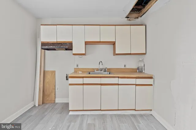 a utility room with cabinets washer and dryer