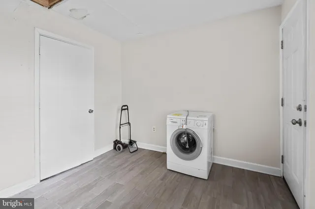 a view of a room with wooden floor and a ceiling fan