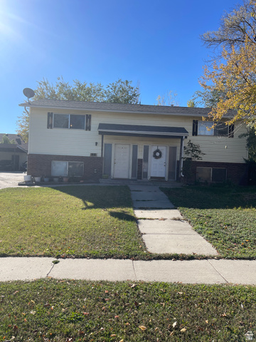3977 Rivendell Road, Unit AB Taylorsville, UT 84129 - Photo 2 of 14 Bi-level home with brick siding and a front lawn