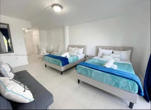 a spacious bedroom with two beds and a couch