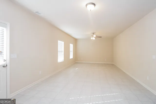 an empty room with a empty space and windows