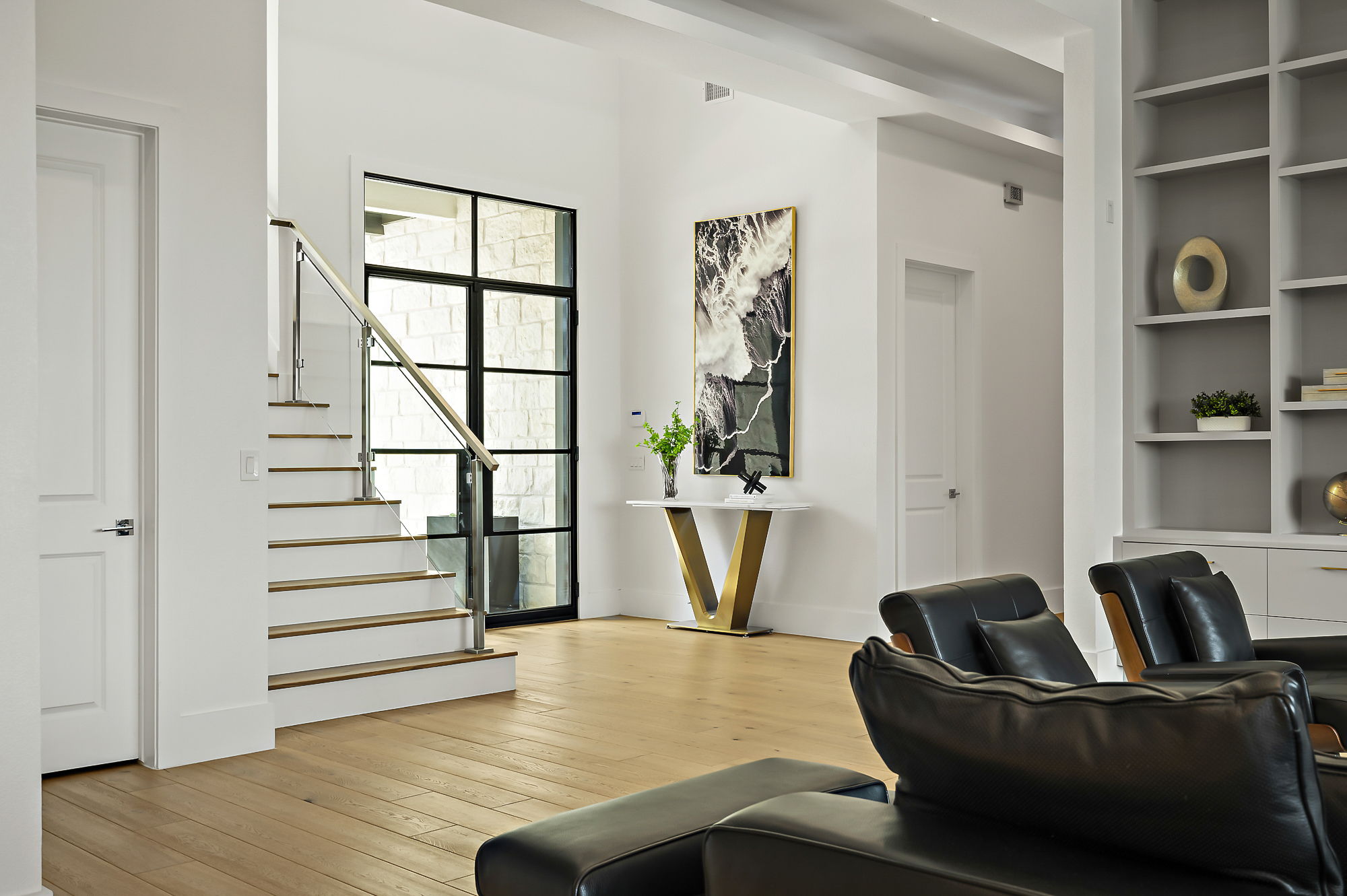 10211 Thistle Ridge Austin, TX 78733 - Photo 4 of 39 Sitting room featuring stairway, wood-type flooring, built in shelves, and baseboards