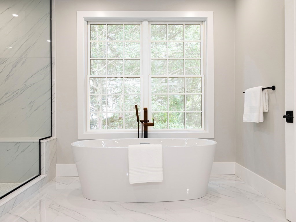 20 Bound Brook Road Newton, MA 02461 - Photo 26 of 40 a white bath tub sitting in a bathroom next to a window