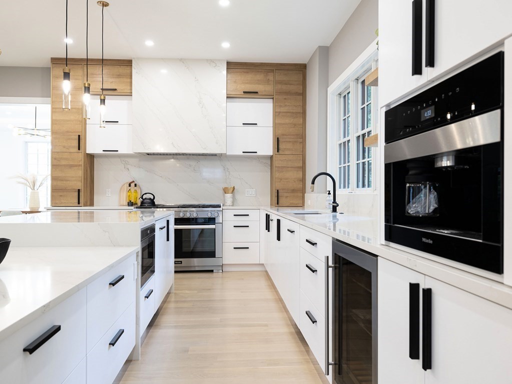 20 Bound Brook Road Newton, MA 02461 - Photo 9 of 40 a large kitchen with stainless steel appliances granite countertop a stove a sink and a microwave
